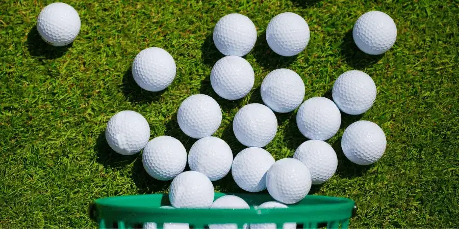 Golf balls lined up, with a total length of approximately 7 inches.