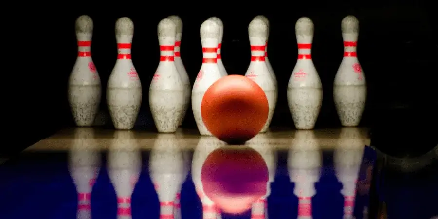 Bowling ball approaching pins, with the ball slightly larger than 7 inches.