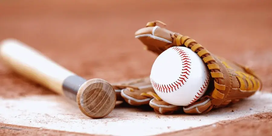 A baseball, around 2.9 inches in diameter, close to 4 inches when measured with one and a half balls.