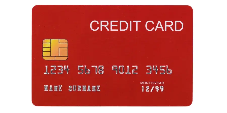 A red credit card, approximately 3.37 inches long, used for quick length estimation.