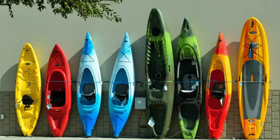 Row of colorful kayaks, showing 10 kayaks lined up to span 100 feet.
