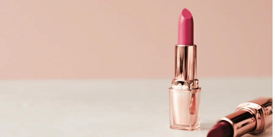 A rose gold lipstick tube measuring about 3 inches in length.