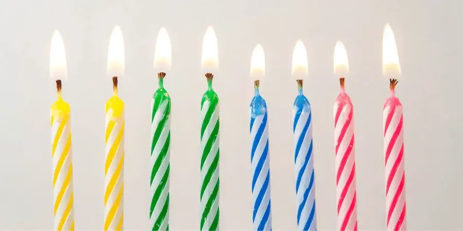Colorful birthday candles burning, each weighing around 1 gram.