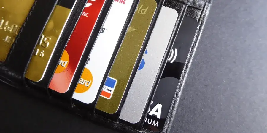 A collection of credit cards in a wallet, showing three cards side by side.