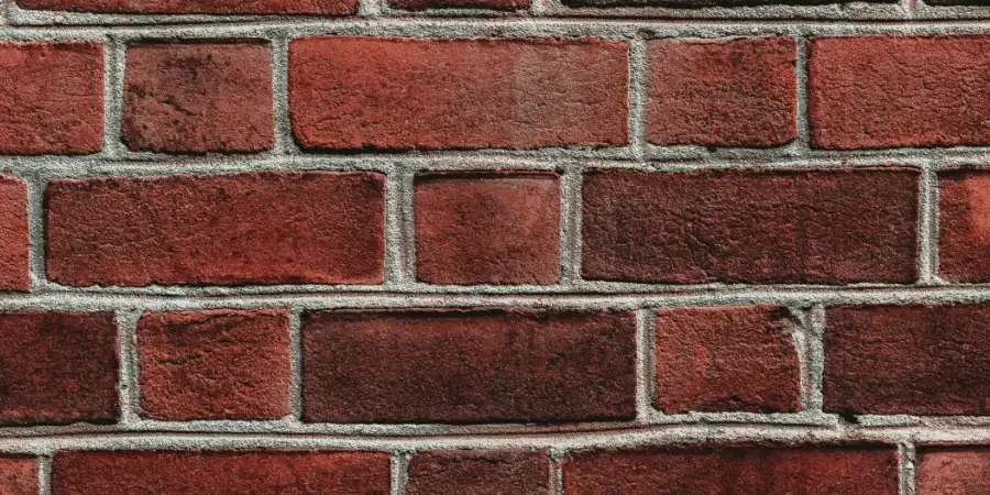 Stacked bricks aligned to represent a 9-inch length for comparison.