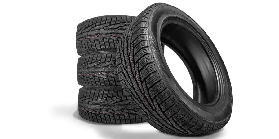 Three stacked car tyres on a white background.
