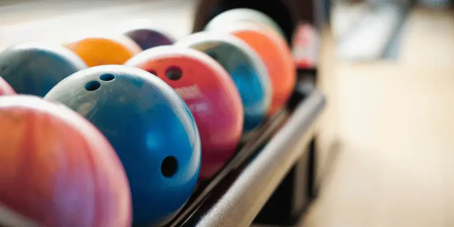 A collection of bowling balls, representing six balls that weigh 30kg together.