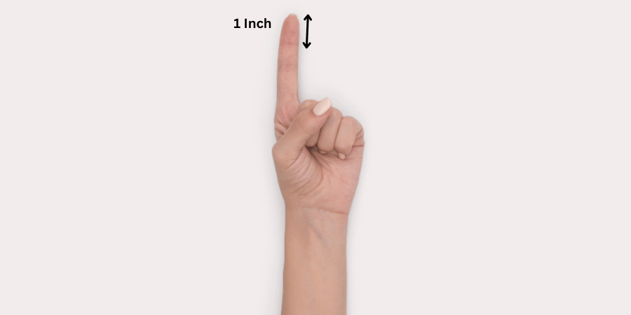 Hand pointing upward with index finger extended, marked with a 1 inch measurement and arrow.