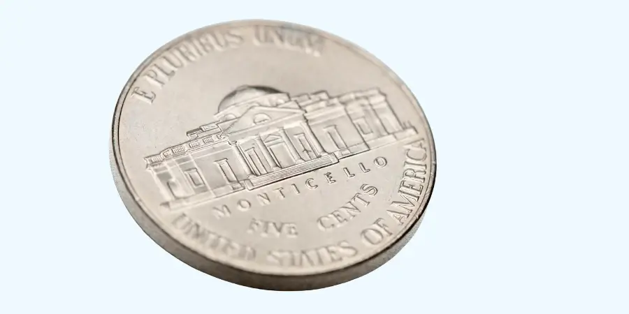 Close-up of a US nickel (five-cent coin) weighing 5 grams, featuring the Monticello building.