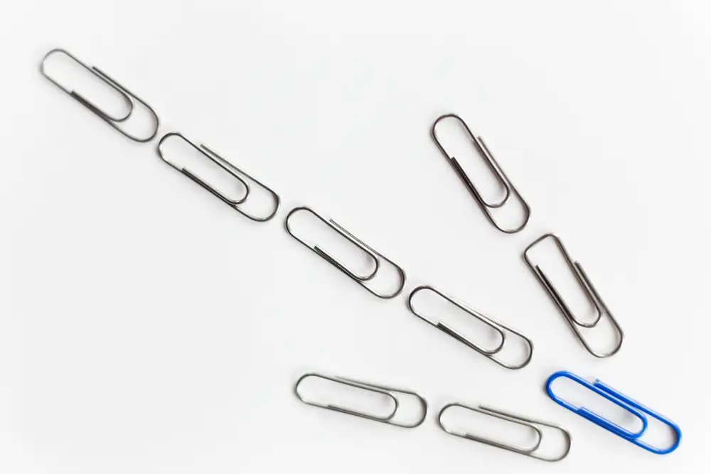 Various paper clips in different colors, showcasing typical office supplies for organizing papers.