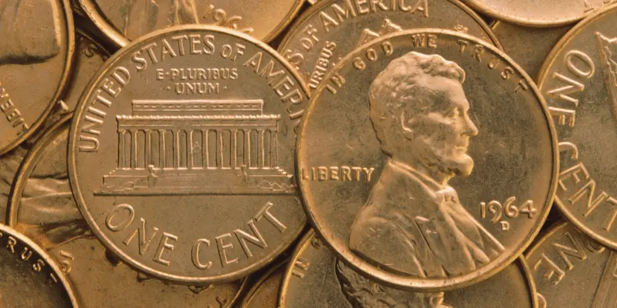 Close-up of US pennies showing Lincoln's portrait and the Lincoln Memorial on the reverse.