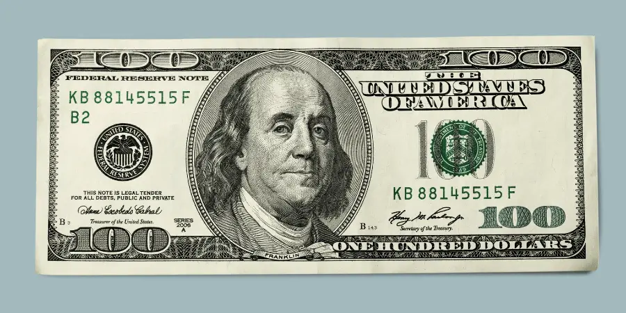 Close-up of a $100 U.S. bill featuring Benjamin Franklin, representing American currency and financial value