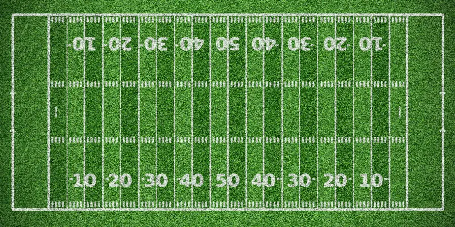 Aerial view of American football field with yard lines, goalposts and green turf for stadium games and team practice now