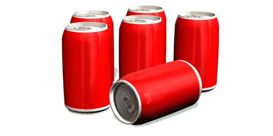 six red soda cans, one slightly tipped over, arranged on a white background showcasing their bright color.