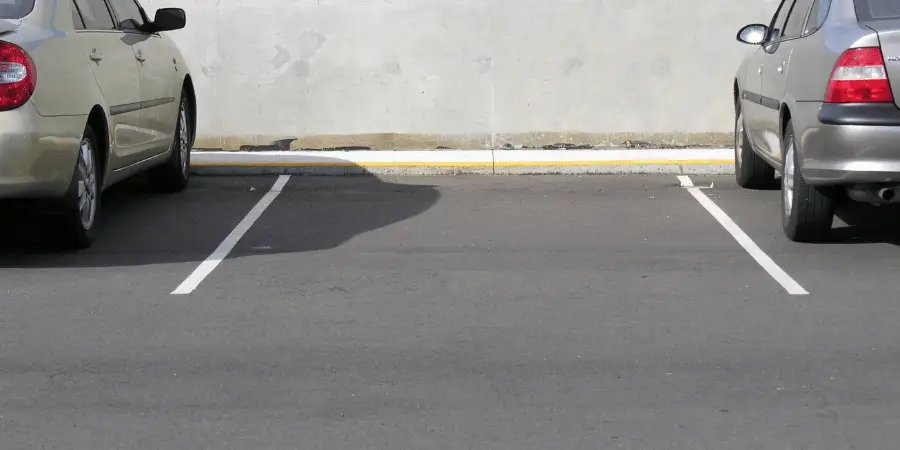 Empty parking spaces with well-defined lines and clear markings for vehicle parking in a lot.