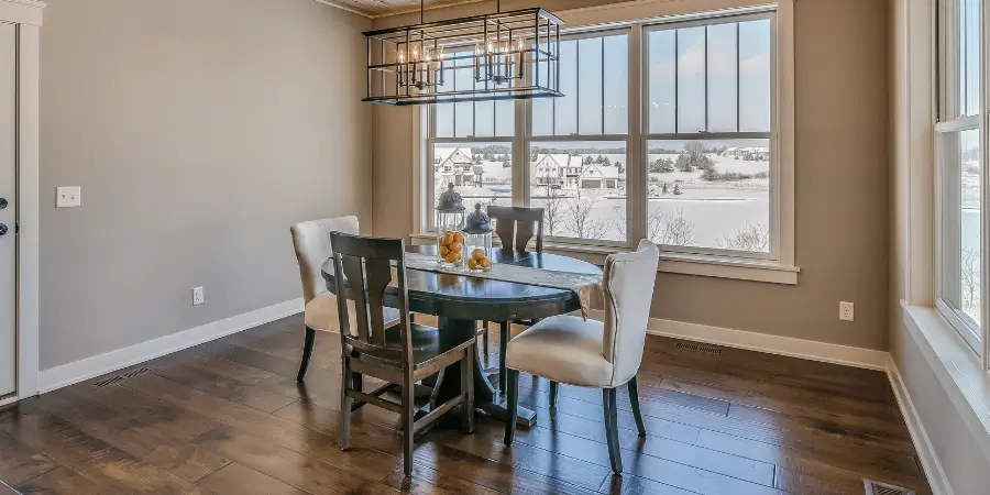 Small dining table with modern chairs, offering a comfy setting for meals in a cozy home.
