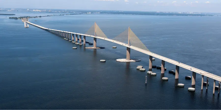Sunshine Skyway Bridge cable-stayed span crossing blue coastal waters, connecting highways supporting vehicular traffic.
