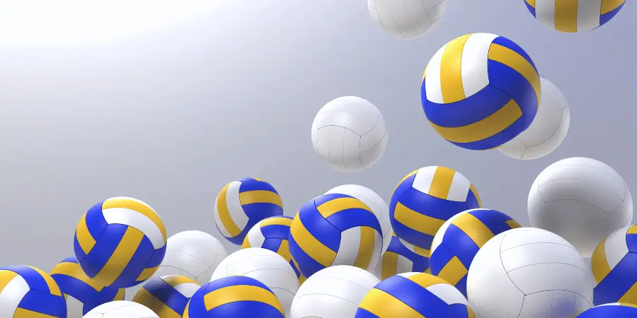 Multiple volleyballs in motion with blue and yellow stripes, illustrating the excitement and energy of a volleyball game.