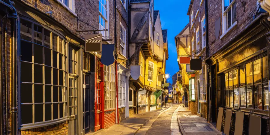 The Shambles in York England, medieval street with timber framed houses, charming shops and historic architecture at dusk.